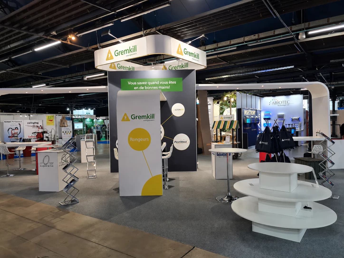 Exhibition stand with an overhead fascia, graphics walls, brochure racks and presentation plinth